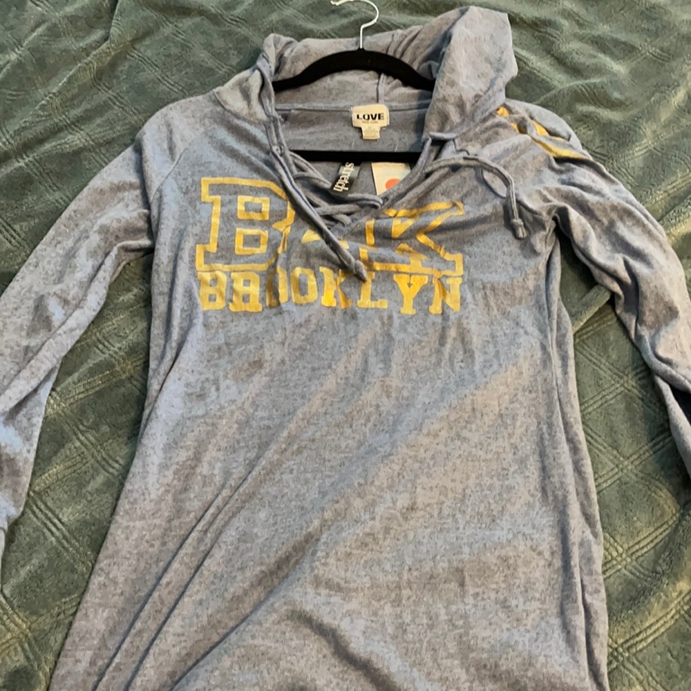 Can be wore as a dress or shirt, medium.